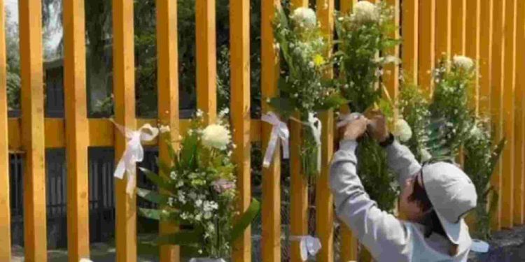 Joven coloca ofrenda a Jesús Israel en la puerta principal del CCH Sur